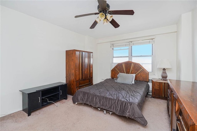 bedroom featuring light colored carpet and ceiling fan