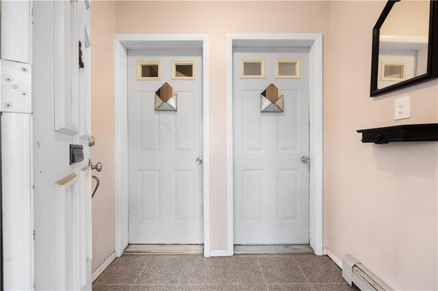 entrance to property featuring a baseboard radiator