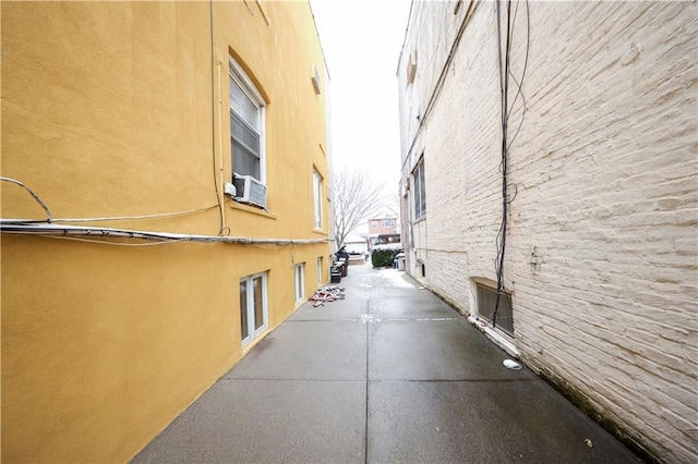 view of side of property featuring cooling unit and a patio area