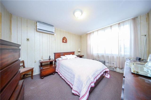 carpeted bedroom with a wall mounted AC