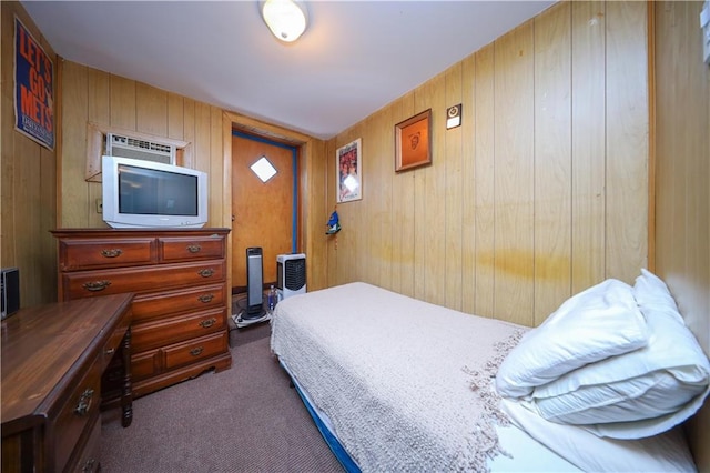 carpeted bedroom featuring wooden walls