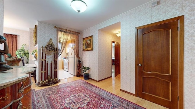 corridor with light hardwood / wood-style flooring