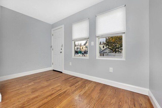 empty room with hardwood / wood-style floors