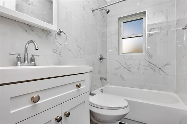 full bathroom with vanity, tiled shower / bath combo, and toilet