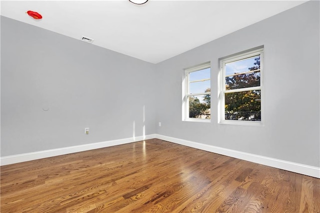 spare room featuring hardwood / wood-style floors