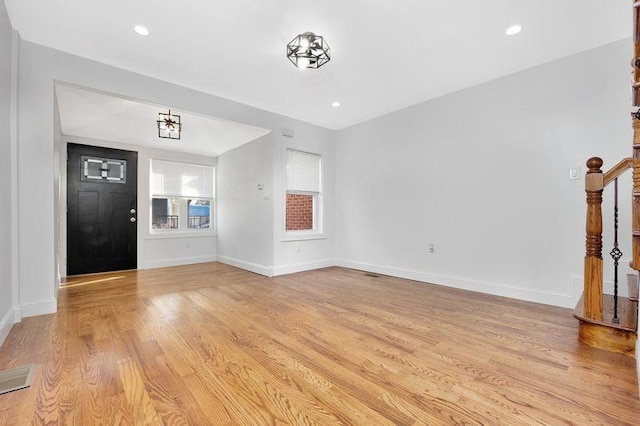 unfurnished living room with light hardwood / wood-style flooring