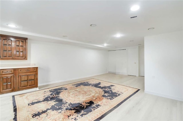 unfurnished room with light wood-style flooring, recessed lighting, and baseboards