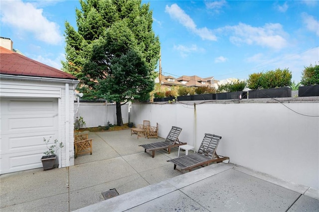 view of patio with a fenced backyard and a garage