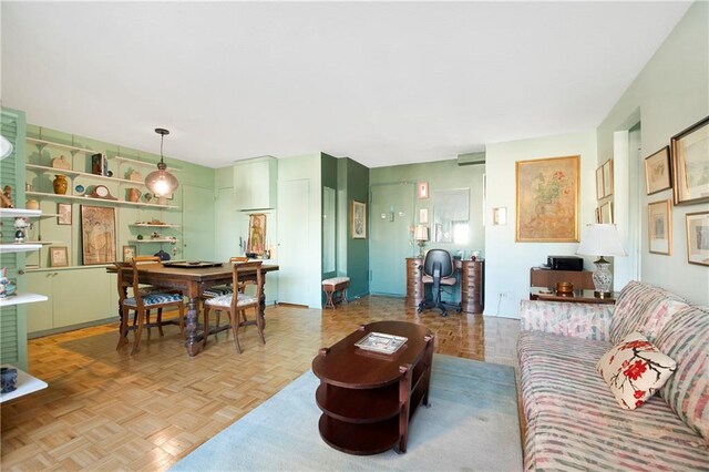 living room featuring built in features and parquet flooring