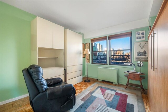 sitting room with radiator and light parquet flooring