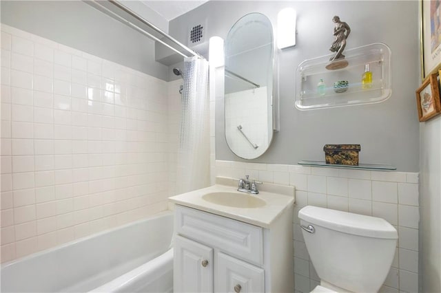 full bathroom with shower / tub combo, vanity, toilet, and tile walls