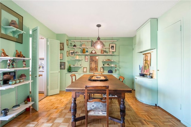 dining space with light parquet flooring