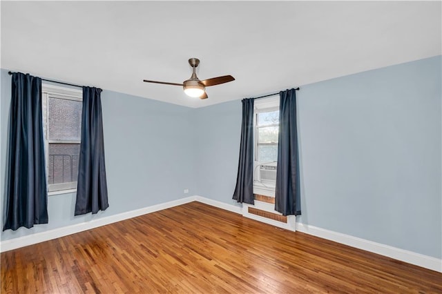 empty room featuring hardwood / wood-style floors and ceiling fan