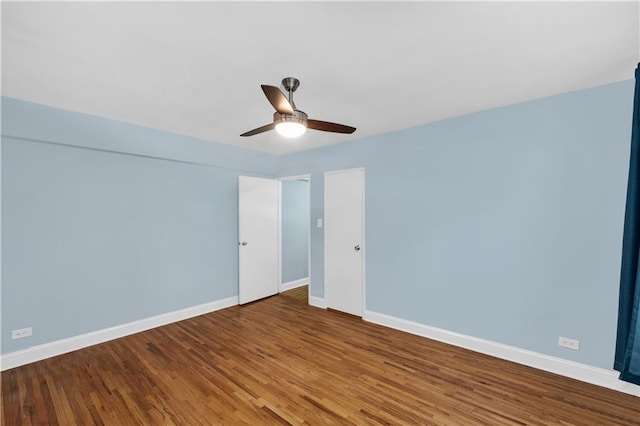 spare room with hardwood / wood-style flooring and ceiling fan