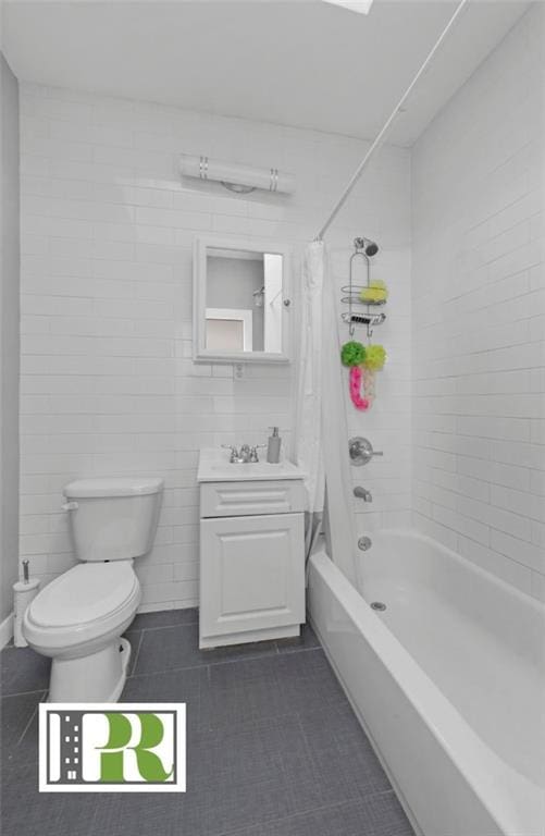 full bathroom with toilet, shower / tub combo, tile walls, vanity, and tile patterned floors