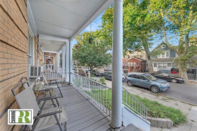 wooden terrace featuring covered porch