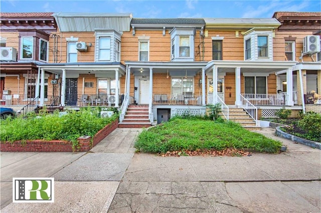 multi unit property featuring covered porch and stairway