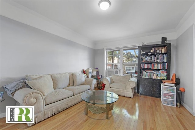 living room featuring baseboards and hardwood / wood-style floors