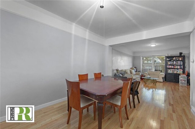 dining area featuring baseboards and hardwood / wood-style flooring