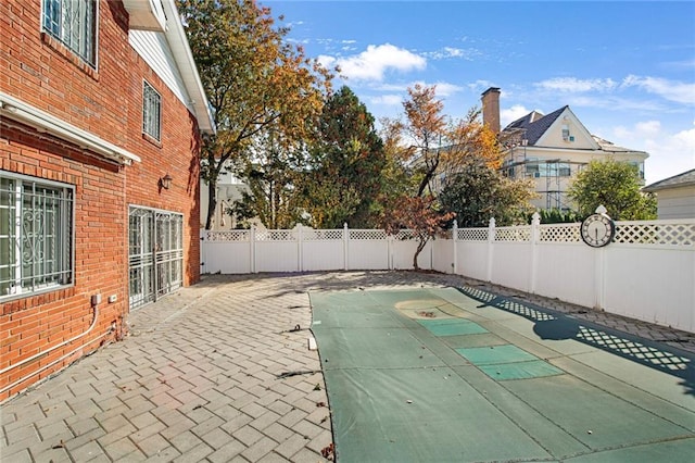 view of swimming pool featuring a patio area and a fenced backyard