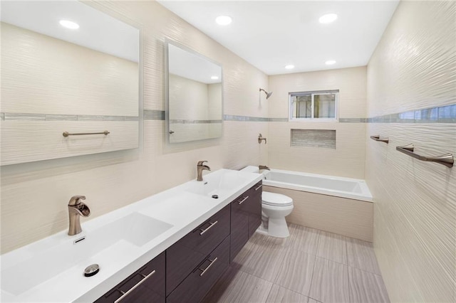 full bathroom featuring tile walls, tiled shower / bath combo, vanity, toilet, and tile patterned floors