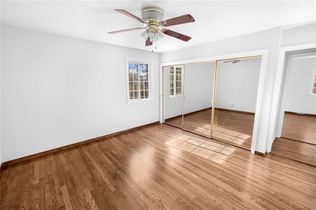 unfurnished bedroom with hardwood / wood-style floors and a closet