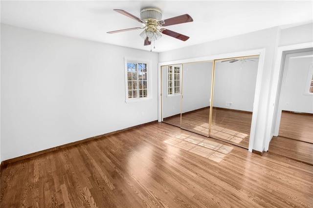 unfurnished bedroom with a ceiling fan, a closet, baseboards, and wood finished floors