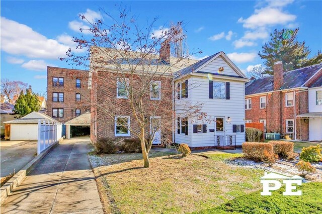 multi unit property featuring a garage, an outdoor structure, and a front yard