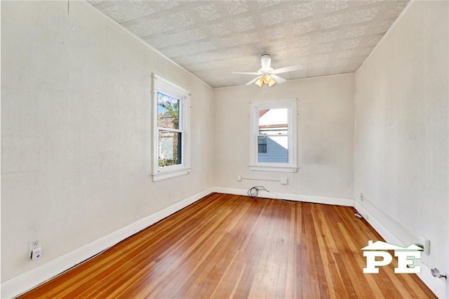 unfurnished room with hardwood / wood-style flooring and ceiling fan