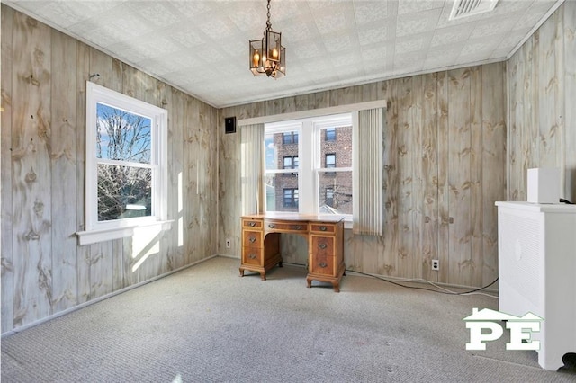 interior space featuring carpet and wooden walls