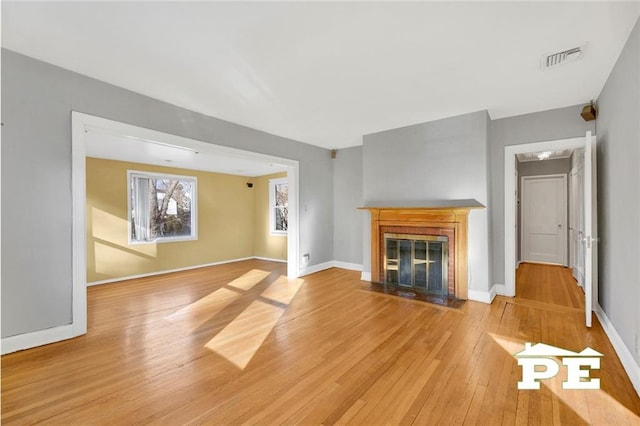 unfurnished living room with light hardwood / wood-style floors