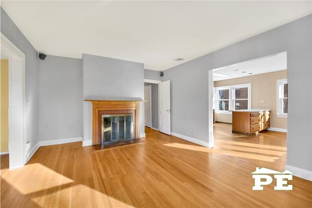 unfurnished living room featuring light wood-type flooring