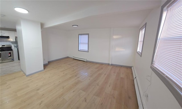 unfurnished room with light wood-type flooring and a baseboard radiator