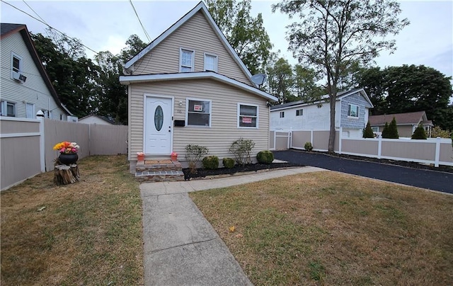 bungalow-style home featuring a front yard