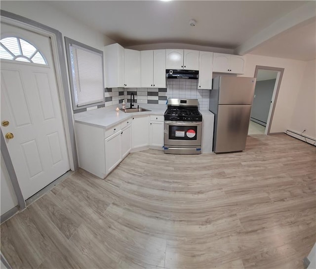 kitchen featuring stainless steel appliances, decorative backsplash, light wood-type flooring, white cabinets, and sink