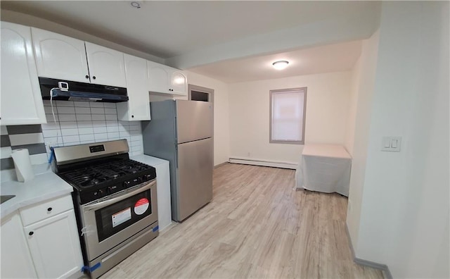 kitchen with backsplash, white cabinetry, light hardwood / wood-style flooring, appliances with stainless steel finishes, and a baseboard radiator