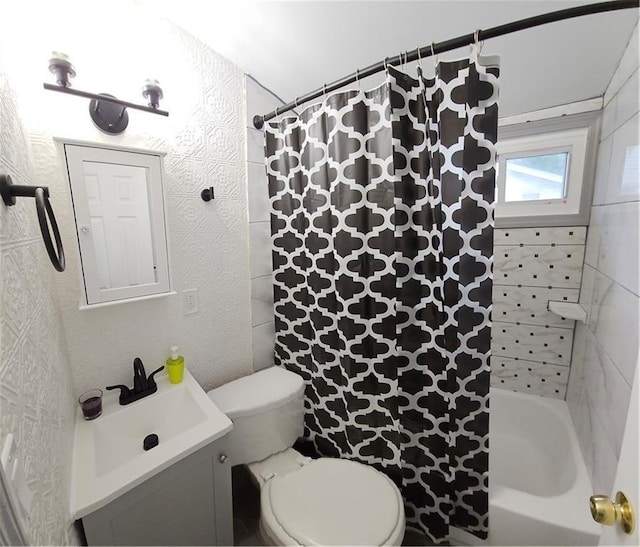 full bathroom featuring toilet, vanity, and shower / bathtub combination with curtain