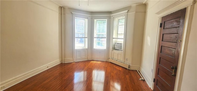 unfurnished room with a baseboard heating unit, baseboards, cooling unit, and dark wood-style flooring