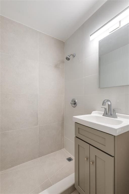 2035 E 7th St Unit 5F, Brooklyn, NY 11223 - full bathroom with vanity, tiled shower, and tile walls