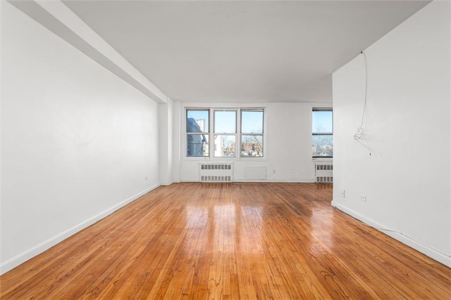 2035 E 7th St Unit 5F, Brooklyn, NY 11223 - empty room featuring radiator heating unit and light wood finished floors
