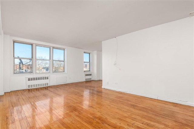 2035 E 7th St Unit 5F, Brooklyn, NY 11223 - empty room with radiator and light wood-style flooring
