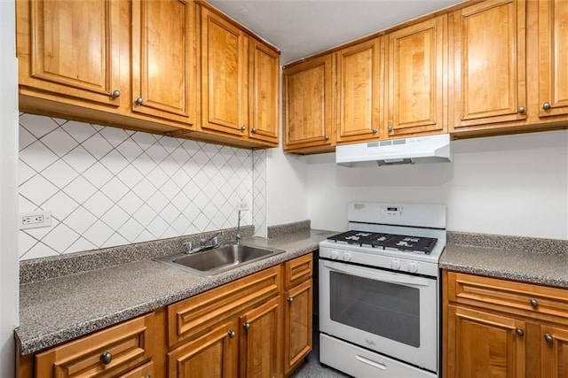 2035 E 7th St Unit 5F, Brooklyn, NY 11223 - kitchen featuring white gas stove, under cabinet range hood, dark countertops, and brown cabinets