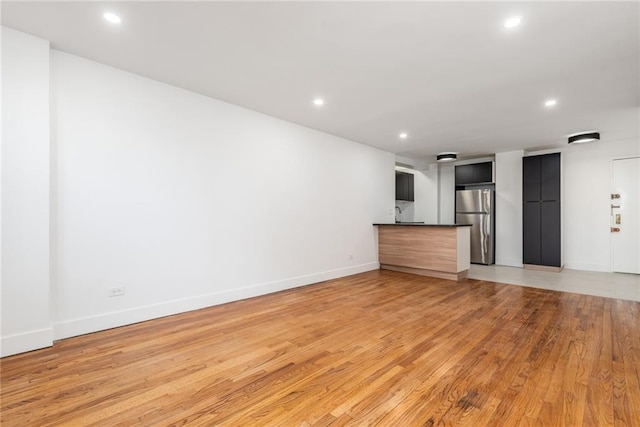 unfurnished living room with wood-type flooring