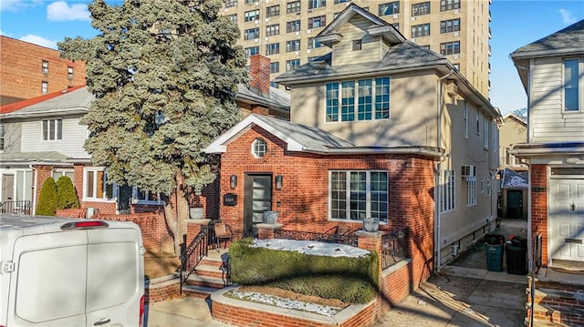 1469 E 5th St, Brooklyn, NY 11230 - view of front facade featuring brick siding, stucco siding, and a shingled roof