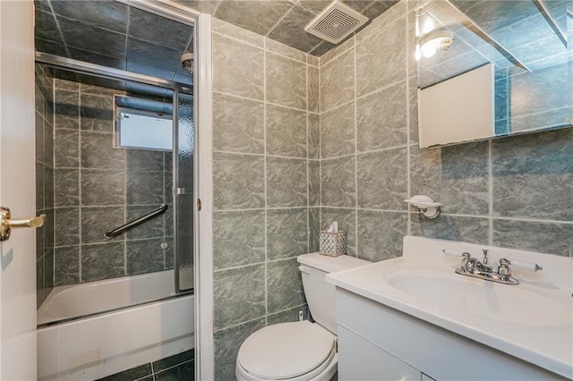 1469 E 5th St, Brooklyn, NY 11230 - bathroom with combined bath / shower with glass door, vanity, toilet, and tile walls