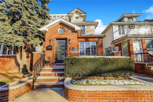 american foursquare style home featuring brick siding