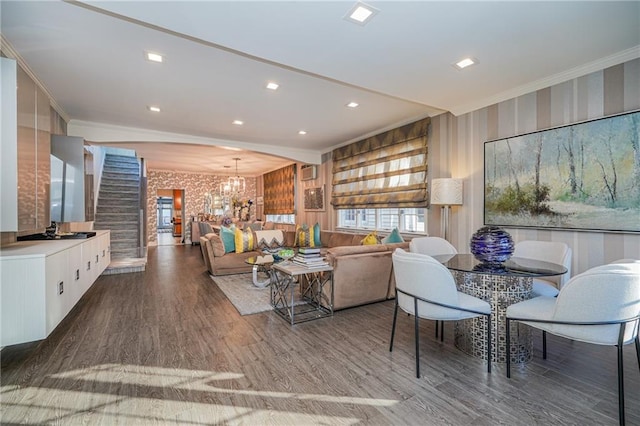 living area with a chandelier, recessed lighting, crown molding, and wood finished floors