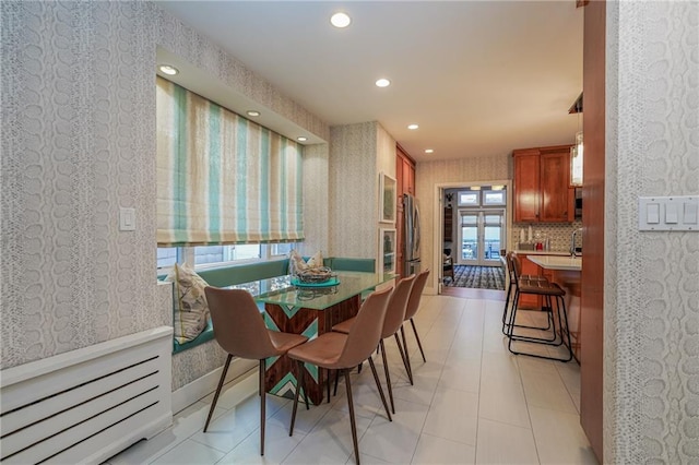 dining room with wallpapered walls and recessed lighting