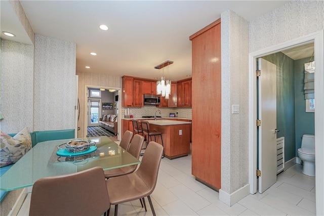 dining area featuring wallpapered walls, baseboards, and recessed lighting