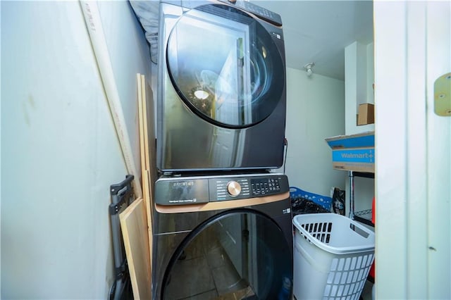 clothes washing area with stacked washer and clothes dryer